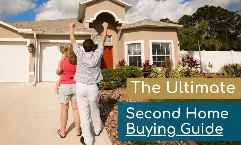 couple with baby in their arms excited in front of house